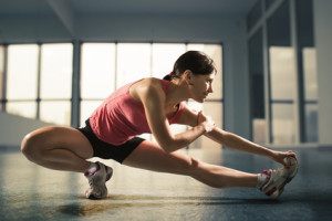 Sports background. Happy woman exercising at the gym