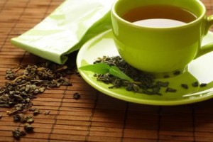  Photo Caption A cup of green tea on a bamboo mat with dried tea leaves Photo Credit Kasiam/iStock/Getty Images 